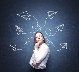 A beautiful woman is pondering about possible solutions of the complicated problem. Many arrows...
