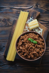 Top view of bolognese sauce, spaghetti and parmesan, studio shot