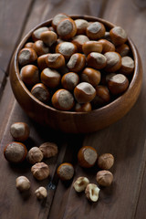 Wooden bowl full of hazelnuts, selective focus, close-up