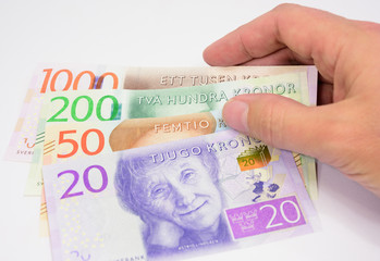 Hand holding new swedish bank notes fanned out. NOTE: the new 2015 model.