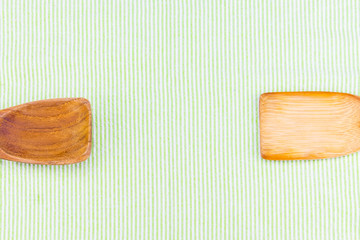 Top view of wooden spoon on green pattern tablecloth, Copy space