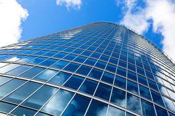 Fototapeta na wymiar business building window wall against blue sky
