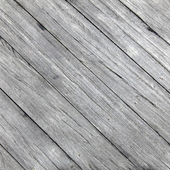 square picture of old rough gray wooden planks diagonally placed