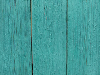 Planks of turquoise wooden fence