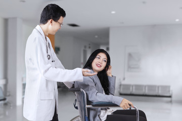 Doctor talking with patient in the hospital corridor