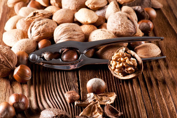 Mixed nuts on a wooden background