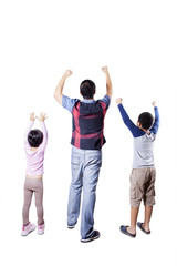 Obraz premium Happy father and children raise hands in studio