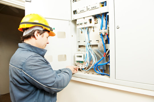 Electrician installing energy saving meter