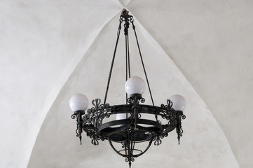 Beautiful chandelier on the ceiling of the old building