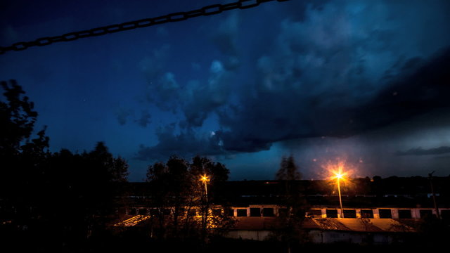 Thunderstorm clouds at night with lightning. Timelapse.