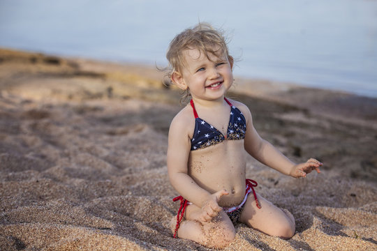 Beautiful child on the beach, playing castley