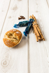 Cupcake with cinnamon on wood