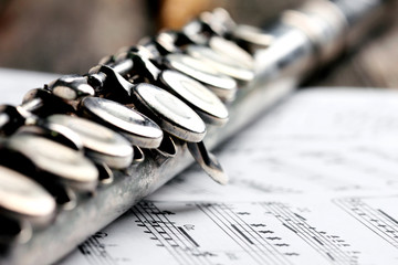 Old silver flute and music notes on rusty table © Zerophoto