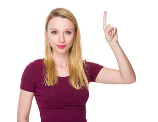 Fototapeta premium Caucasian young woman holding finger up