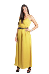 Attractive sensual beauty in ocher jumpsuit looking at camera isolated