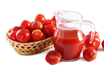 Fresh red tomatoes in basket and tomato juice in glass isolated