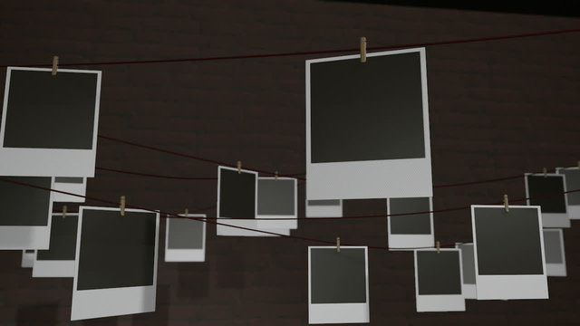 A zoom out reveal of a front view  of a collection of many blank polaroid films pinned to a cork bulletin board with various colored pushpins