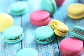Tasty colorful macarons on a blue wooden table
