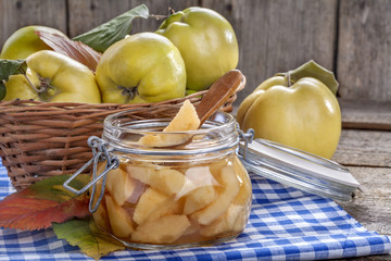 canned fresh and healthy quince on an old wooden table
