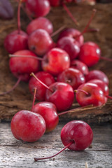 .Small wild and healthy organic apples on an old wooden table