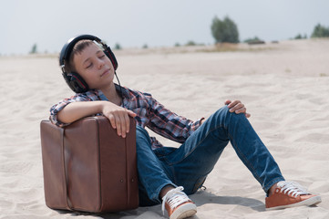 Teenager listening to music on the beach