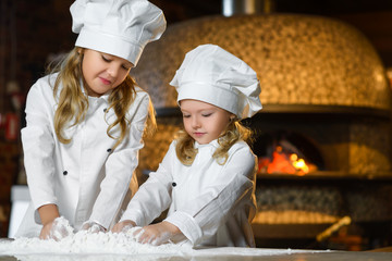 Making the dough for pizza is fun - little chefs playing with