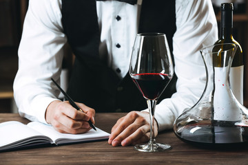Bartender working at counter on bar background