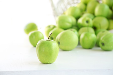 Green apples in wicker basket, closeup