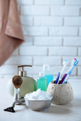 Male luxury shaving kit on shelf, on bricks wall background