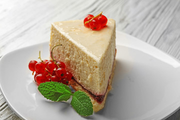 Delicious cheesecake with berries on table close up