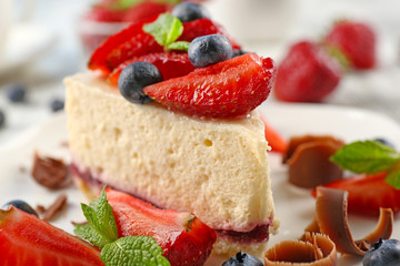 Delicious cheesecake with berries on table close up