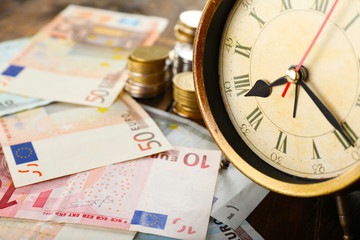 Money and alarm clock, closeup