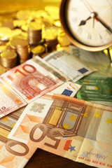 Money and alarm clock, closeup