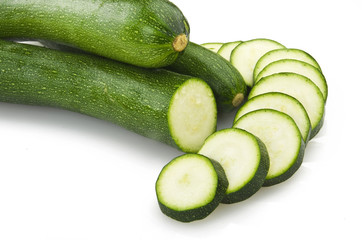 Fresh zucchini sliced close up on the white
