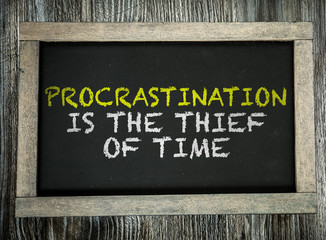 Procrastination is the Thief of Time written on chalkboard