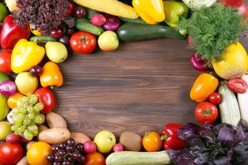 Heap of fruits and vegetables on wooden background