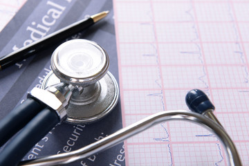 Stethoscope on cardiogram  sheet, closeup
