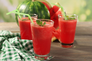 Glasses of watermelon juice on wooden table, closeup