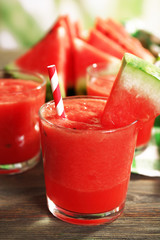 Glasses of watermelon juice on wooden table, closeup