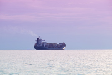 The image of a cargo ship in a open sea