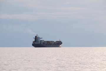 The image of a cargo ship in a open sea