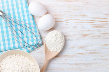 Baking ingredients on white wooden background