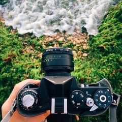 holding an old film camera