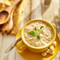 clam chowder with green herb garnish in square composition