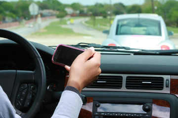 Person texting and driving with car in view