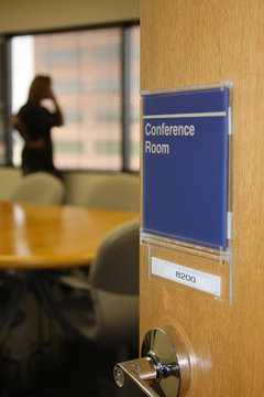 Person talking on phone in a conference room