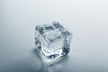 Concept of perfection - ice cube on grey background