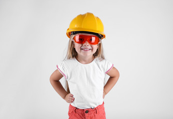 Little girl with toy tools isolated on white