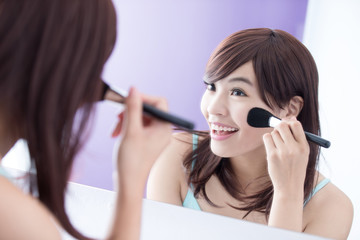 Smile woman with makeup brushes