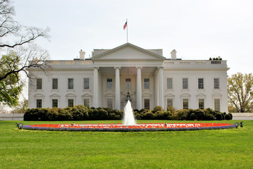 Fototapeta na wymiar The White House with fountain, perfect grass garden and sky with clouds - Washington DC 